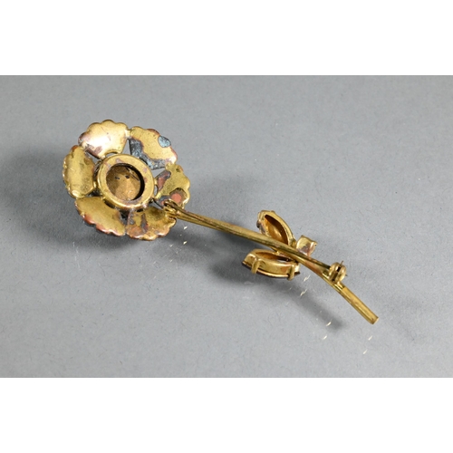 306 - A vintage paste-set brooch in the form of a flower with long stem and leaf decoration, the coloured ... 