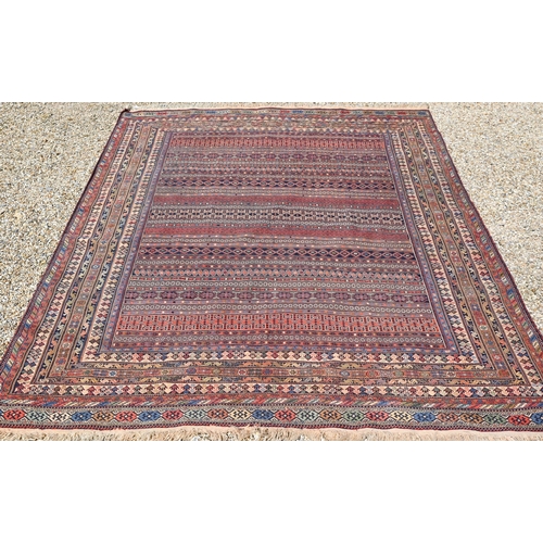 828 - A vintage Moroccan geometric design Sumak weave carpet, multi-coloured bands within conforming borde... 