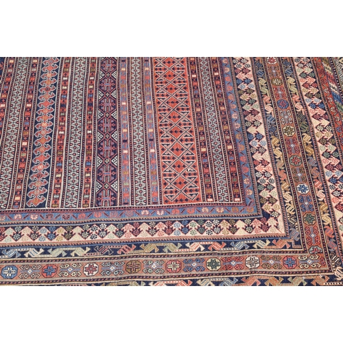 828 - A vintage Moroccan geometric design Sumak weave carpet, multi-coloured bands within conforming borde... 