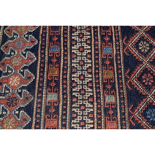 828 - A vintage Moroccan geometric design Sumak weave carpet, multi-coloured bands within conforming borde... 