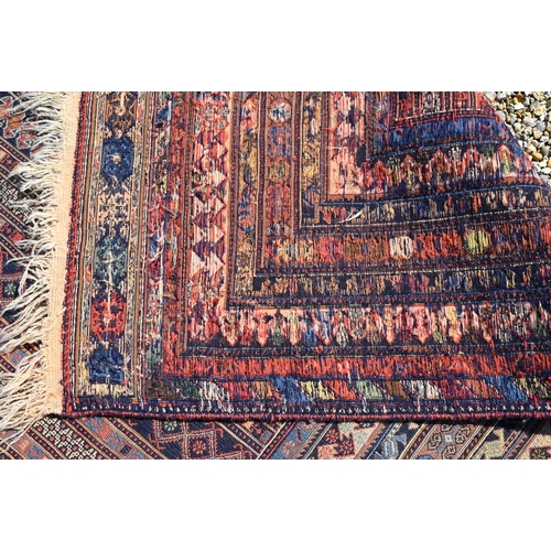 828 - A vintage Moroccan geometric design Sumak weave carpet, multi-coloured bands within conforming borde... 