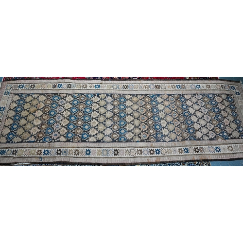 819 - A large old Caucasian kelim, the interlinked design in muted tones on camel ground, 418 cm x 142 cm