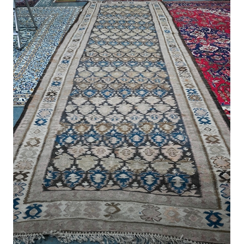 819 - A large old Caucasian kelim, the interlinked design in muted tones on camel ground, 418 cm x 142 cm