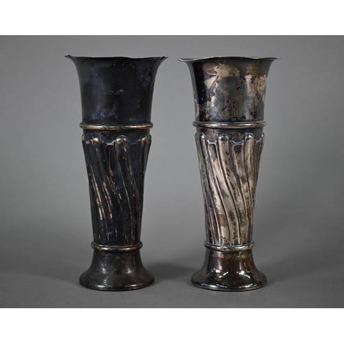 101 - An Edwardian pair of loaded silver vase-flutes, Walker & Hall Sheffield 1901, 21cm high, to/w a ... 