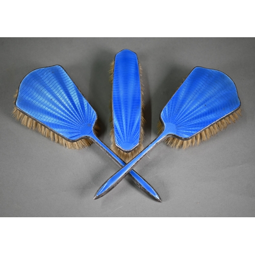 102 - An unmarked blue enamelled three-piece brush set