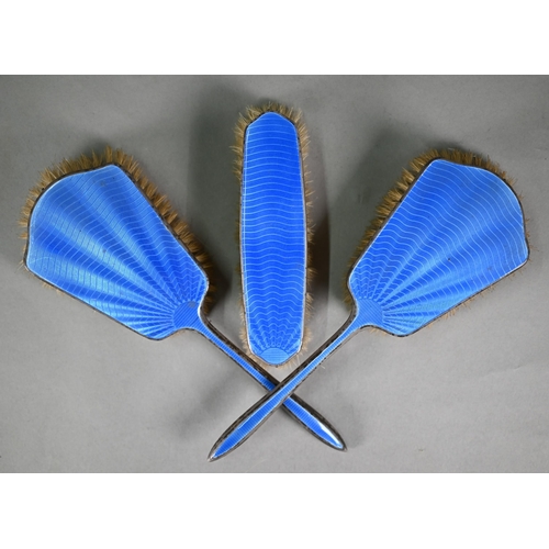 102 - An unmarked blue enamelled three-piece brush set