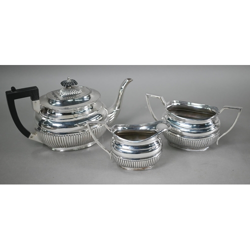 11 - A plated on copper circular tray, to/w a half-reeded three-piece tea service, a hot water jug and a ... 