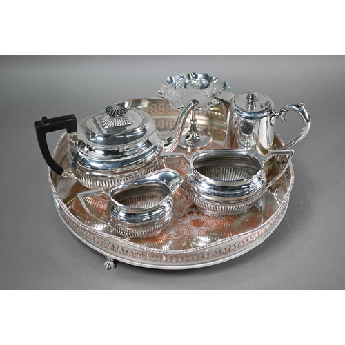 11 - A plated on copper circular tray, to/w a half-reeded three-piece tea service, a hot water jug and a ... 