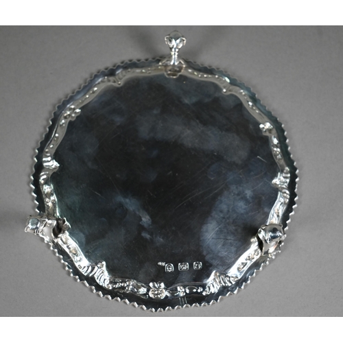 111 - An early George III silver card salver with gadrooned and floral-embossed rim, on claw and ball feet... 