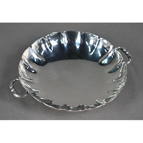 115 - A circular silver small dish with twin loop handles and moulded foot-rim, Adie Brothers, Birmingham ... 