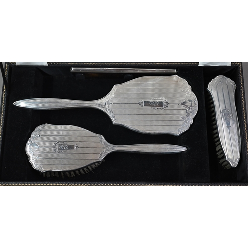 116 - A cased silver four-piece brush set including comb and hand-mirror, Birmingham 1959 (little used)