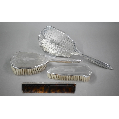 116 - A cased silver four-piece brush set including comb and hand-mirror, Birmingham 1959 (little used)