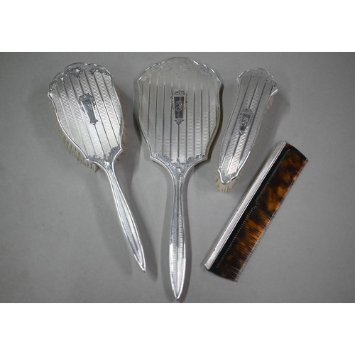 116 - A cased silver four-piece brush set including comb and hand-mirror, Birmingham 1959 (little used)