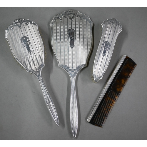 116 - A cased silver four-piece brush set including comb and hand-mirror, Birmingham 1959 (little used)