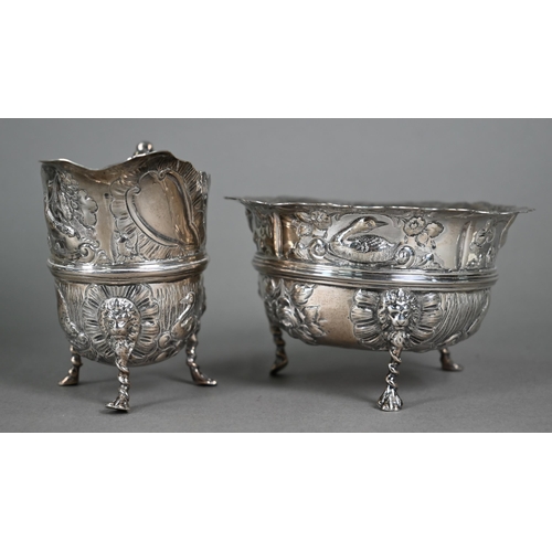 124 - A late Victorian heavy quality silver three-piece tea service, embossed and chased with birds, fish ... 