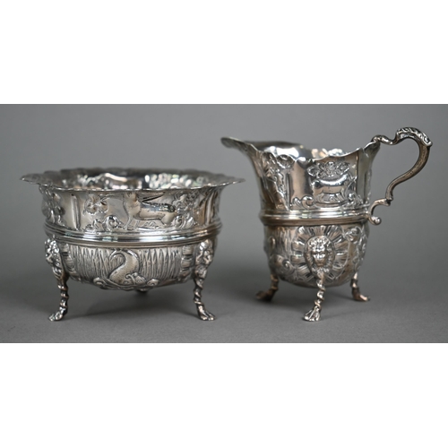 124 - A late Victorian heavy quality silver three-piece tea service, embossed and chased with birds, fish ... 