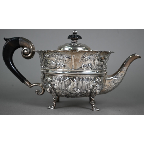 124 - A late Victorian heavy quality silver three-piece tea service, embossed and chased with birds, fish ... 