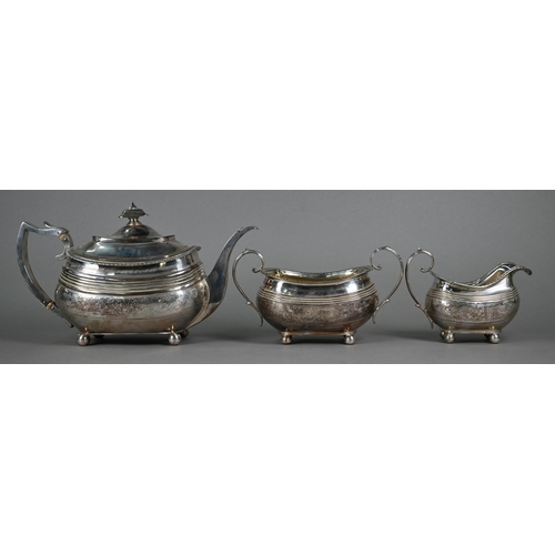 131 - A Regency silver three-piece tea service of oblong form, with gadrooned rims and engraved decoration... 