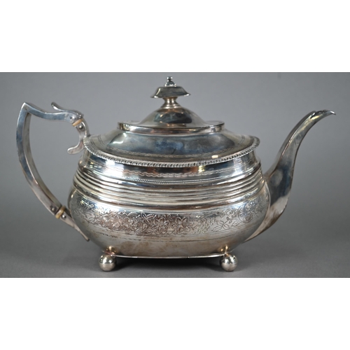 131 - A Regency silver three-piece tea service of oblong form, with gadrooned rims and engraved decoration... 