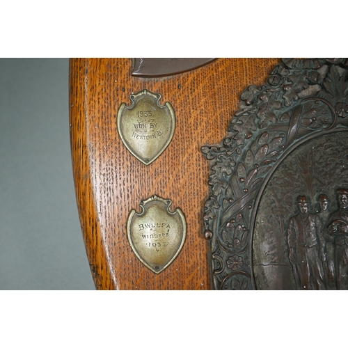 135 - A large oak trophy shield for the Aberdare Quoit Association, with central copper plaque embossed wi... 