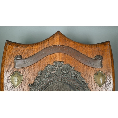 135 - A large oak trophy shield for the Aberdare Quoit Association, with central copper plaque embossed wi... 