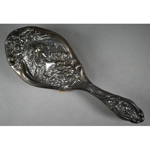 142 - An Edwardian Art Nouveau silver hairbrush and hand-mirror, moulded in bas relief with Ophelia in pro... 