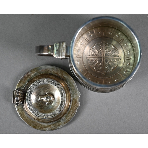 146 - A silver miniature replica tankard with embossed and chased decoration, distributed by the Merchant ... 