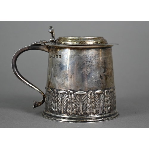 146 - A silver miniature replica tankard with embossed and chased decoration, distributed by the Merchant ... 