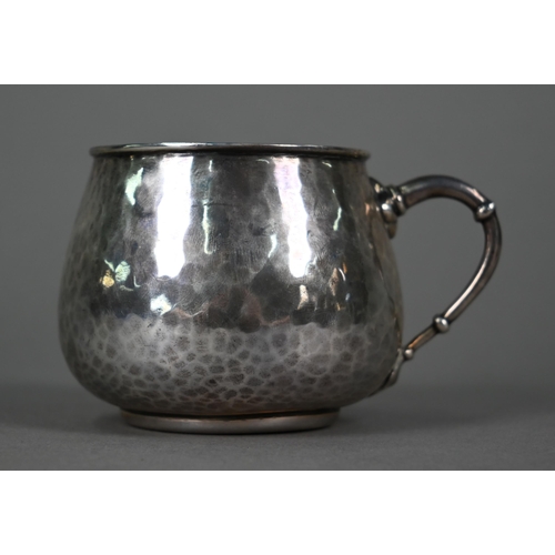 147 - Liberty & Co.  A planished silver pot-bellied Christening mug with knopped loop handle, Birmingh... 