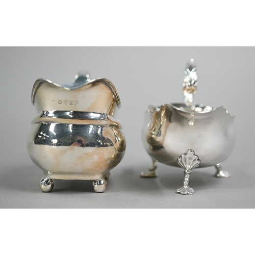 191 - A mid Georgian silver pot-bellied sauce-boat with cut rim, scroll handle and shell feet, engraved ba... 