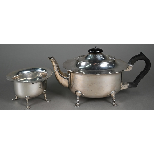 196 - A heavy quality silver teapot with cut rim, pad feet and composite handle and finial, to/w  the matc... 