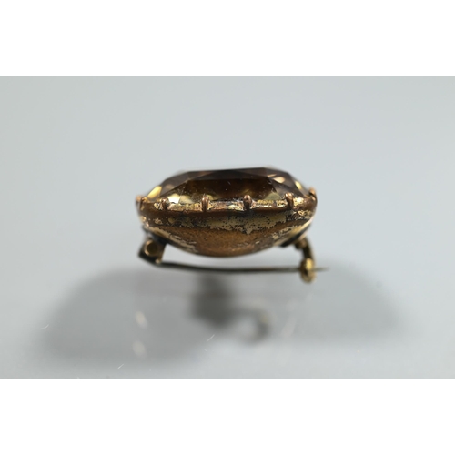 200 - A Georgian foil back brooch set with a cushion-cut rock crystal, the unmarked yellow metal brooch wi... 