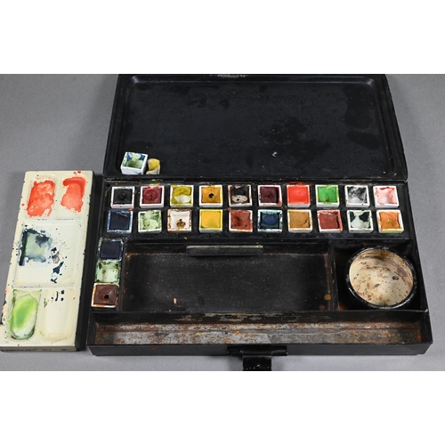 205 - An Edwardian artist's black japanned watercolour box, the hinged lid with gilded coat of arms and ma... 