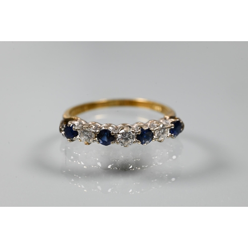 206 - An 18ct yellow gold ring set with three oval blue sapphires with two diamonds between, size P to/w a... 