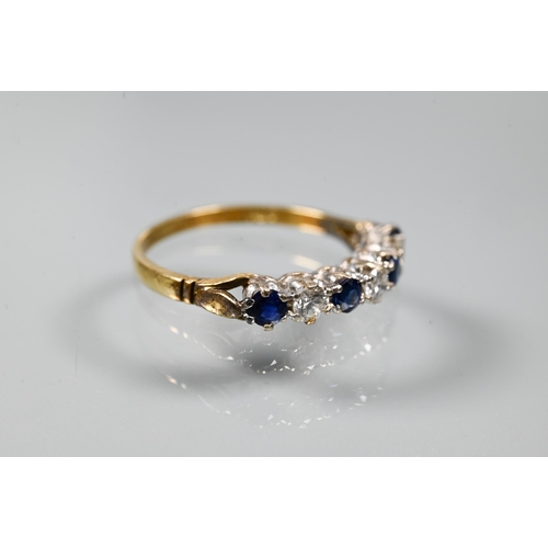 206 - An 18ct yellow gold ring set with three oval blue sapphires with two diamonds between, size P to/w a... 