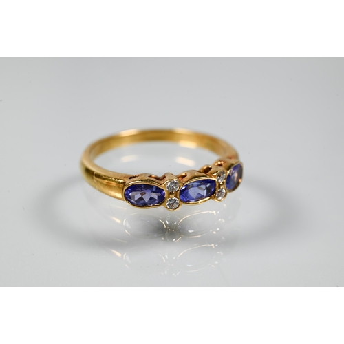 206 - An 18ct yellow gold ring set with three oval blue sapphires with two diamonds between, size P to/w a... 