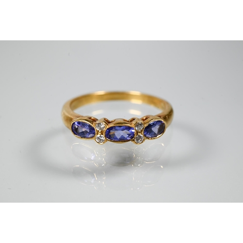 206 - An 18ct yellow gold ring set with three oval blue sapphires with two diamonds between, size P to/w a... 