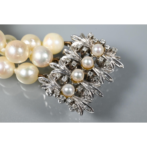 214 - A pearl bracelet, the three-rows of cultured pearls knotted throughout onto fancy white metal set pe... 