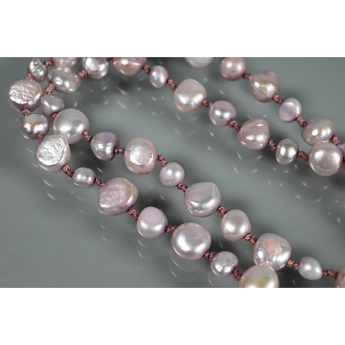 218 - Two Baroque pearl necklaces, one white 50 cm long, the other pink, 45 cm (closed), both knotted thro... 