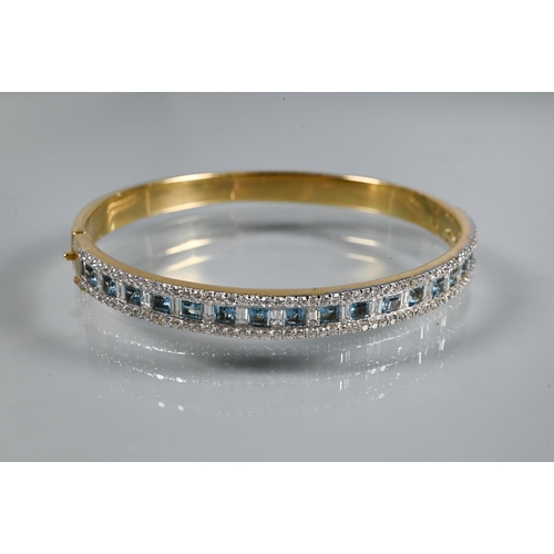 219 - A diamond and blue topaz suite comprising half-hinged bangle with alternate channel-set diamonds and... 