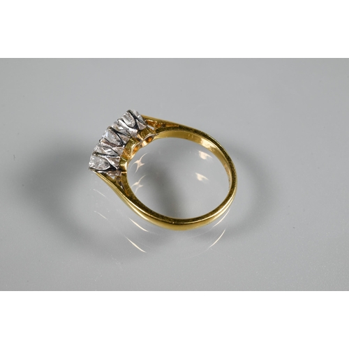 231 - A three-stone diamond ring, the graduated diamonds claw set in platinum, with 18ct yellow gold shank... 