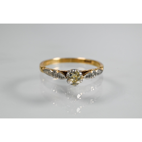 239 - A single stone diamond ring, the claw set diamond of pale yellow hue in 18ct yellow and white gold s... 