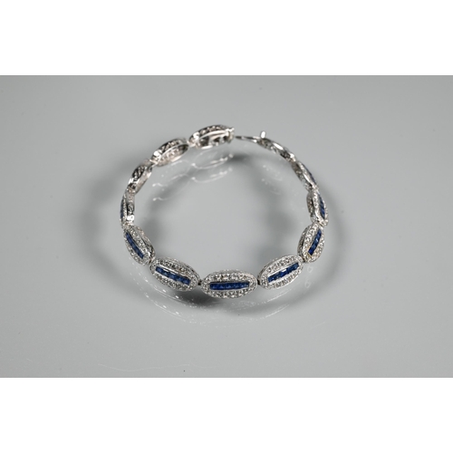 244 - An 18ct white gold Art Deco style sapphire and diamond set bracelet formed of oval links with five g... 