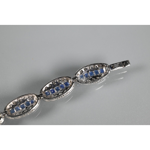 244 - An 18ct white gold Art Deco style sapphire and diamond set bracelet formed of oval links with five g... 