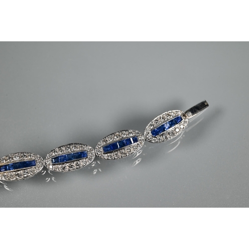 244 - An 18ct white gold Art Deco style sapphire and diamond set bracelet formed of oval links with five g... 