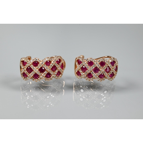 249 - A ring and earring suite stamped 'Royal', with ruby and diamond lattice-work design, rose metal set ... 