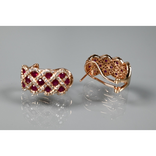 249 - A ring and earring suite stamped 'Royal', with ruby and diamond lattice-work design, rose metal set ... 