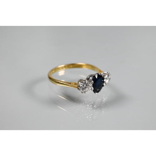 255 - A three-stone sapphire and diamond ring, the central oval blue sapphire with a circular diamond to e... 