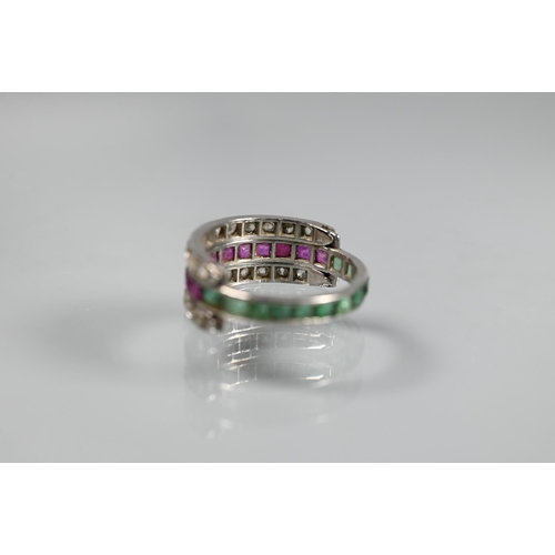 261 - A trio 'Day/Night' ring, white metal set with channel set diamonds, rubies and emeralds, size M