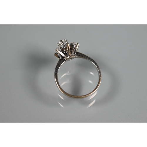 262 - A diamond cluster ring in the form of a star, the central diamond in high claw setting above a starb... 